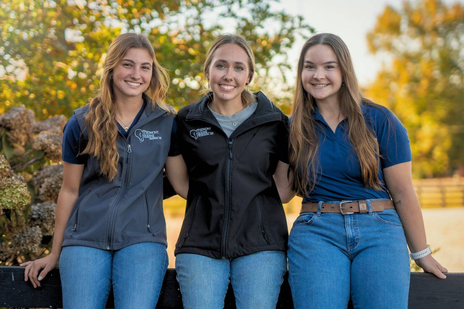 Join our team of equine veterinary staff Three Vet Staff smiling and leaning against a fence